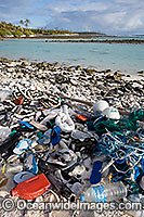 Marine pollution rubbish trash garbage comprising of plastic bottles, footwear and fishing implements washed ashore by tidal movement on a remote tropical island beach - probably drifting in from Indonesia. Cocos (Keeling) Islands, Indian Ocean, Australia